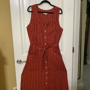 Maxi dress with full skirt belted waist in rust color with white pin stripes
